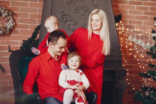 Family sitting at home near christmas tree