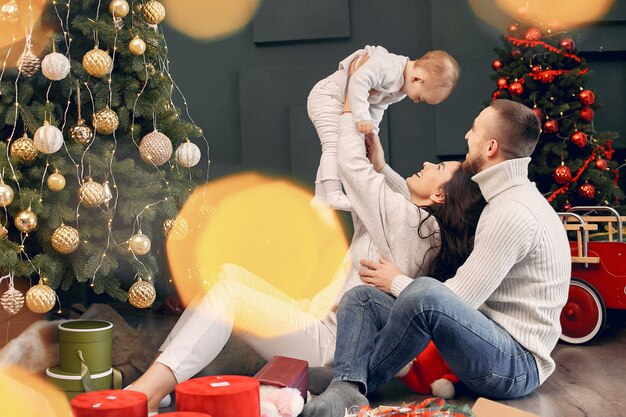 Family sitting at home near christmas tree