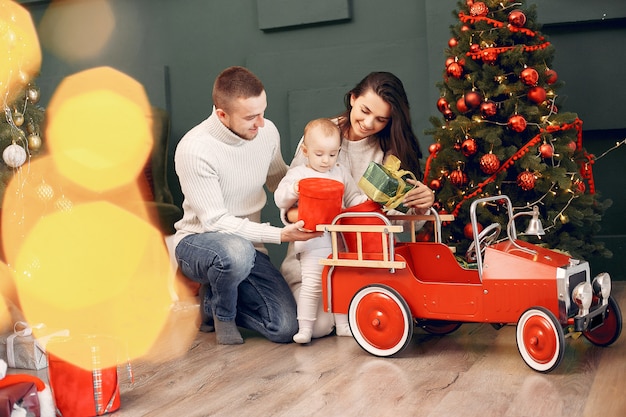 Family sitting at home near christmas tree