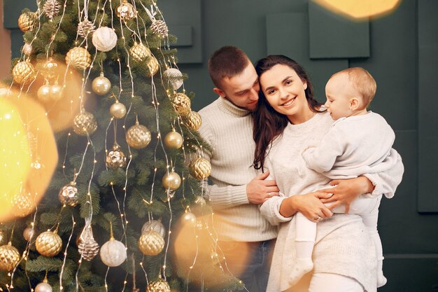 Family sitting at home near christmas tree