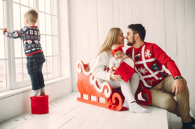 Family sitting at home with christmas gifts