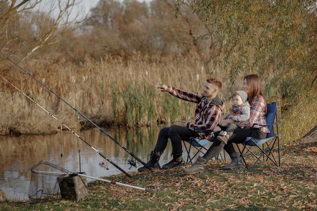 아침 낚시에서 강 근처에 앉아 가족