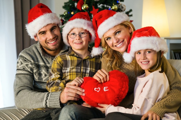 Free photo family smiling with santa hats