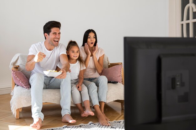 Family spending time in front of tv