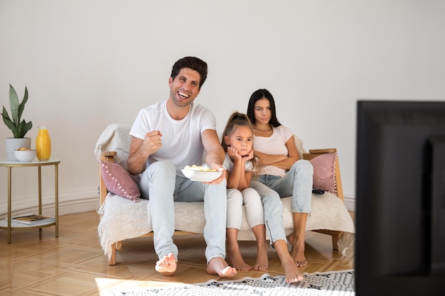 Free photo family spending time in front of tv