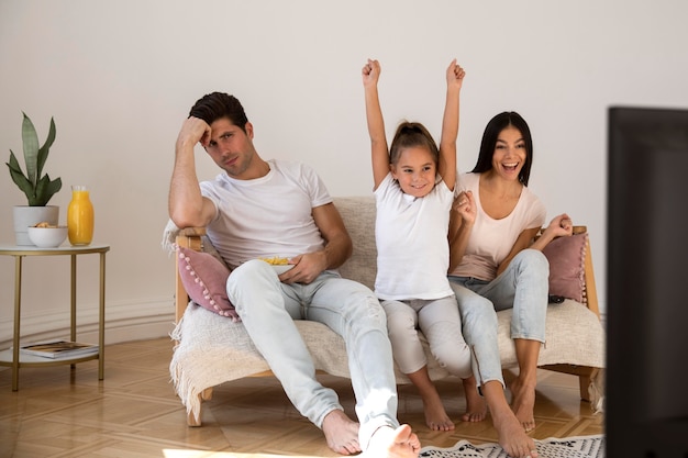 Family spending time in front of tv