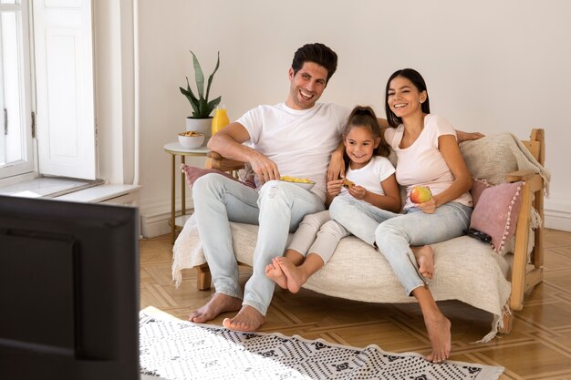 Family spending time in front of tv
