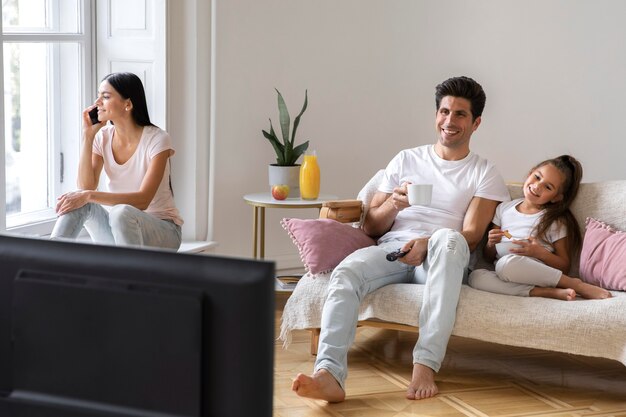 Family spending time in front of tv