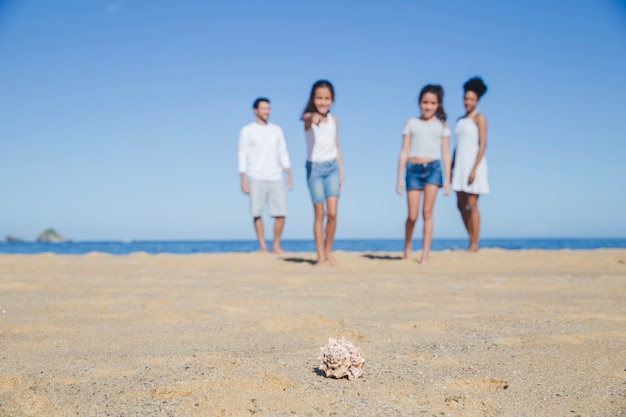 Family standing at the beach