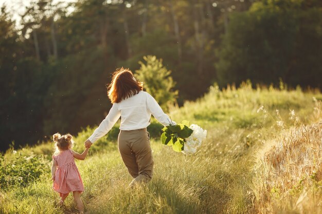 Family in a summer field. Sensual photo. Cute little girl.