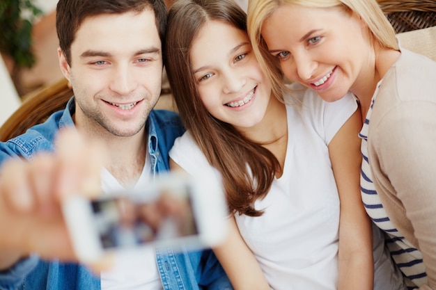 Free photo family taking a photo