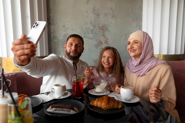 Family taking selfie together while out at a restaurant