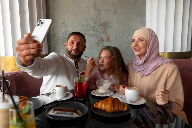 Family taking selfie together while out at a restaurant