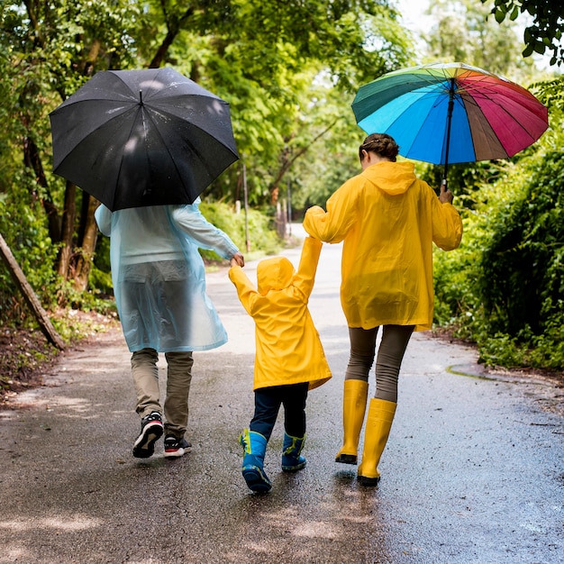 Family taking a walk in the rain