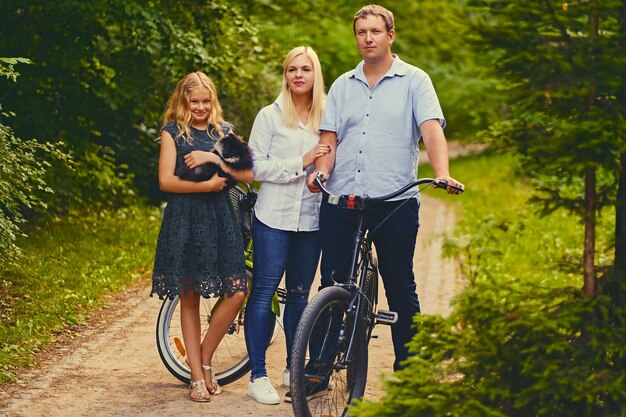 A family and their Spitz dog in a park.