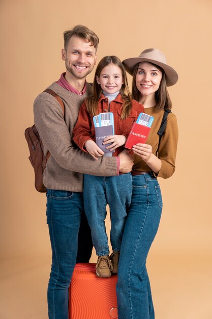 Family of three ready for traveling with passport and plane tickets