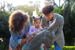 Free photo family of three spending time together outdoors on father's day