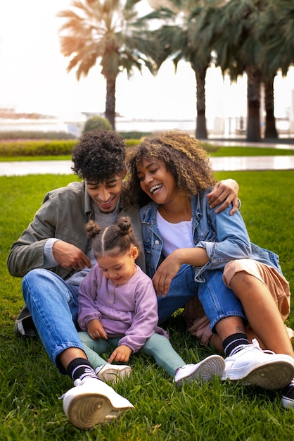 Free photo family of three spending time together outdoors on father's day