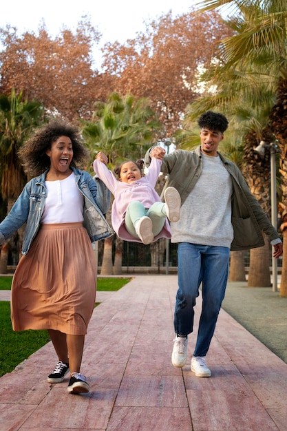 Family of three spending time together outdoors on father's day