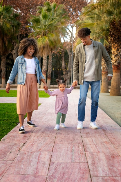 Family of three spending time together outdoors on father's day