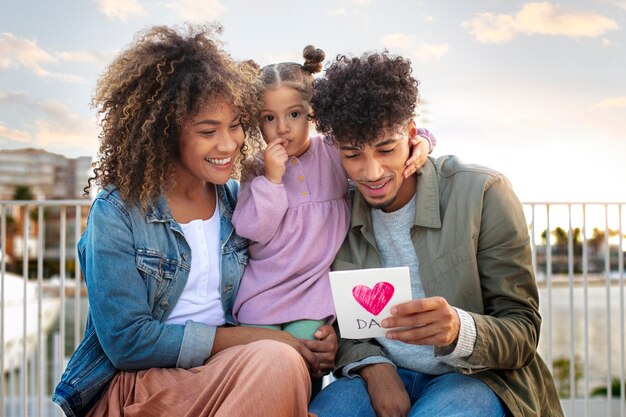 family of three spending time together outdoors on father's day