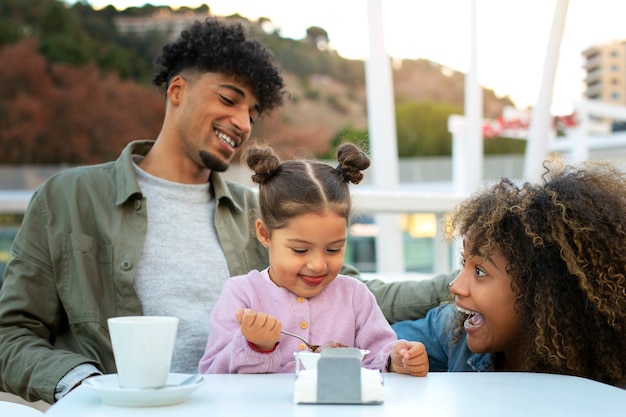 Family of three spending time together outdoors on father's day