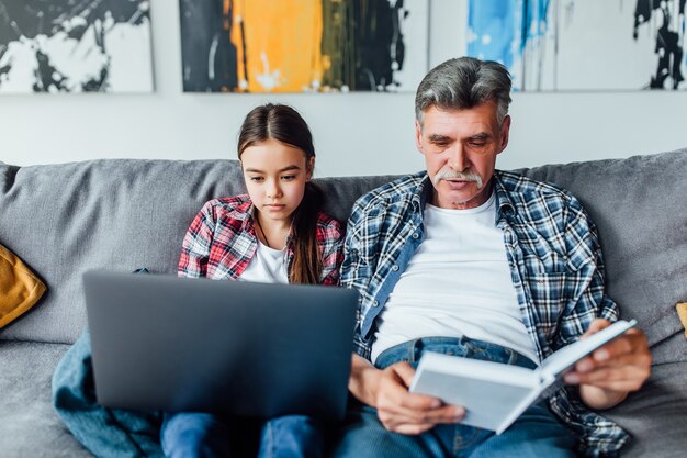 Family time! Grandfather helping granddaughter  with homework.