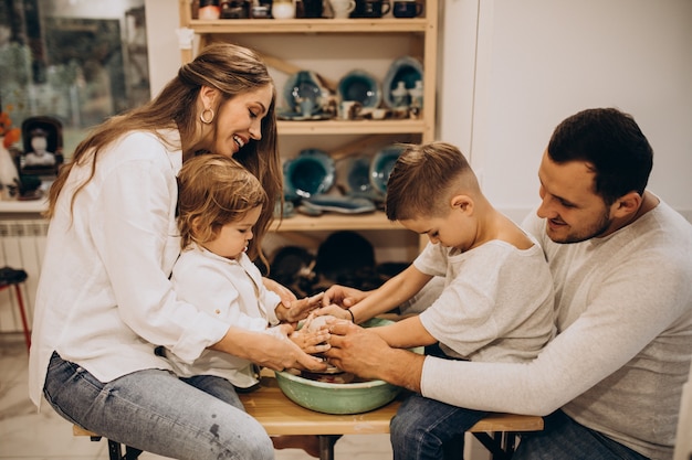 Family together manufacturing at a pottery class