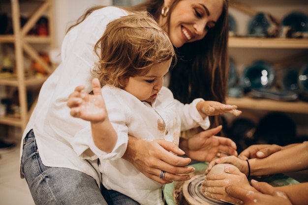 Family together manufacturing at a pottery class