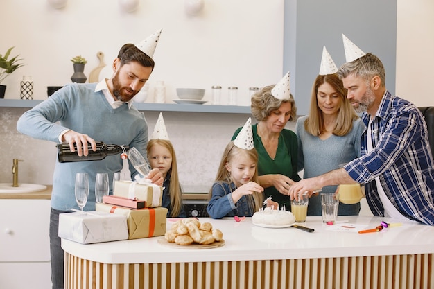 Family and two their daughters have a celebration of grandmothers birthday People is going to drink