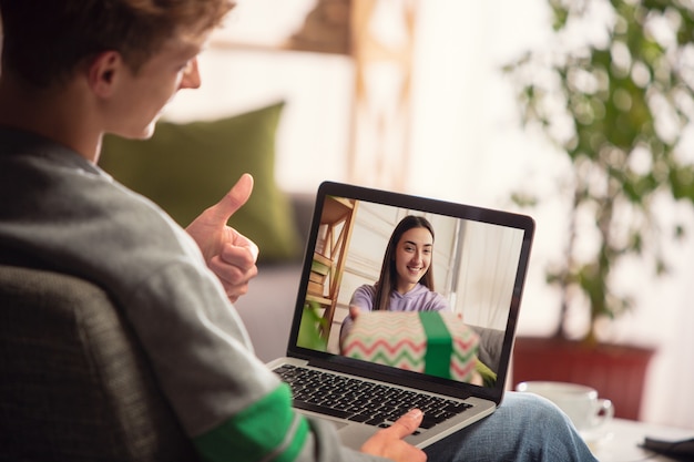 Family unpacking gifts on videocall