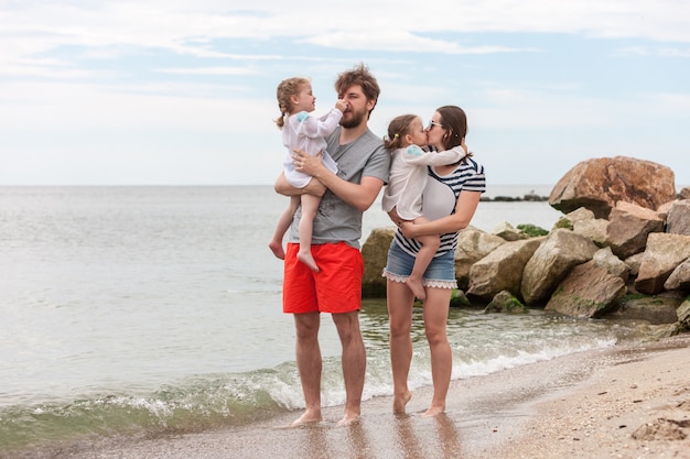 Family vacation parents and children on the sea shore summer day