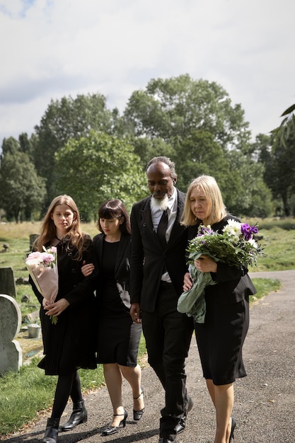 Free photo family visiting grave of loved one