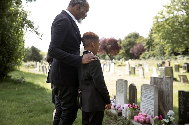 Free photo family visiting grave of loved one