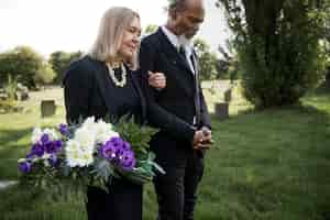 Free photo family visiting grave of loved one