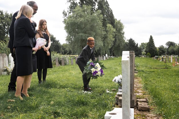 family visiting grave of loved one