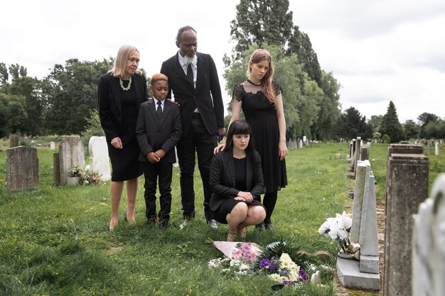 family visiting grave of loved one