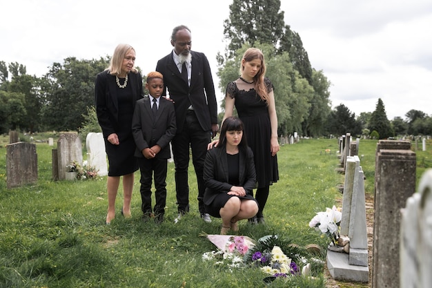 Family visiting grave of loved one