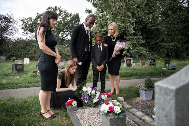 family visiting grave of loved one