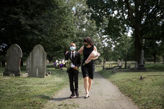 family visiting grave of loved one