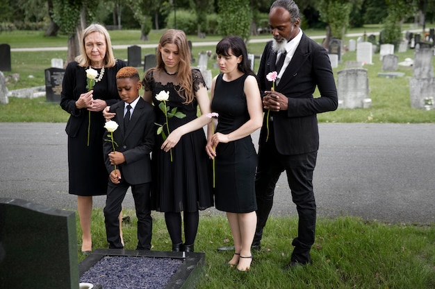 Free photo family visiting grave of loved one