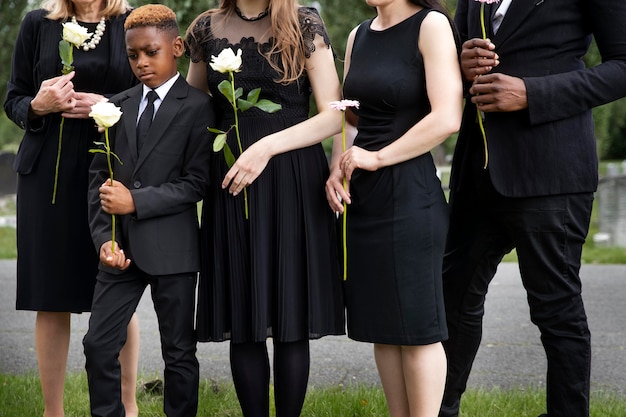 family visiting grave of loved one