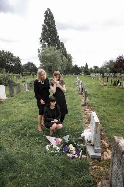 Family visiting grave of loved one