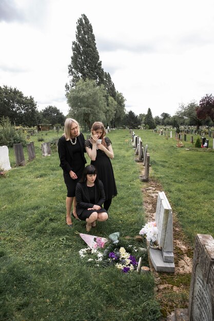 family visiting grave of loved one