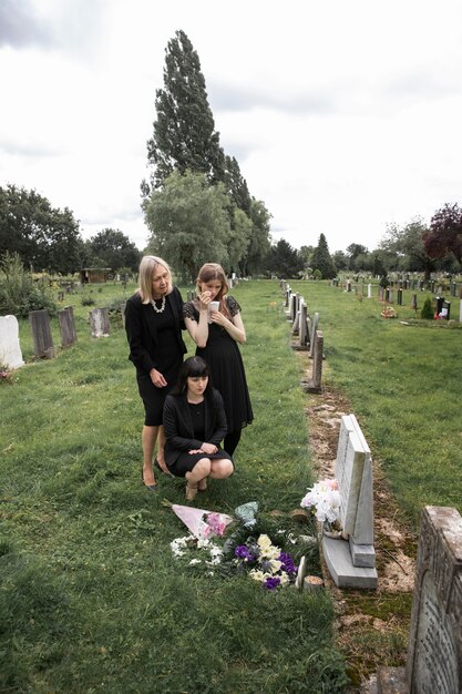 Family visiting grave of loved one