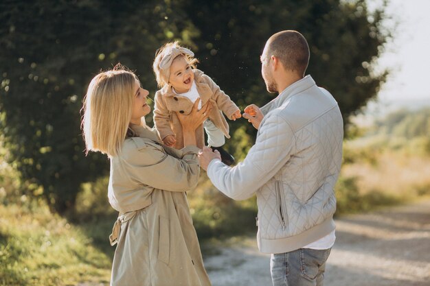 Family walks in a field Little girl child in the summer meadow Woman in a white shirt