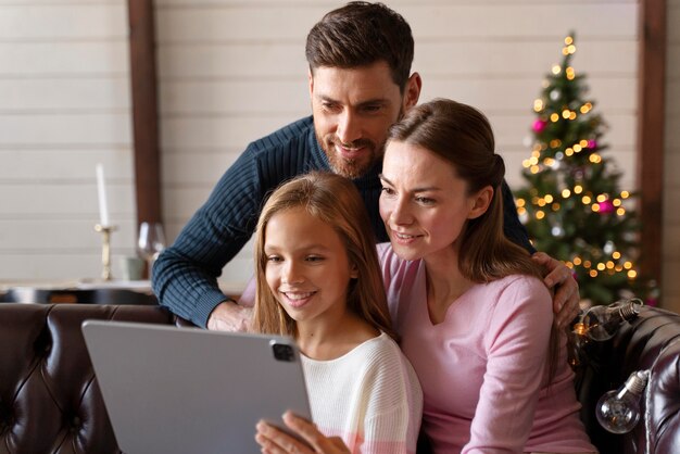 Family watching a video on their tablet on christmas day