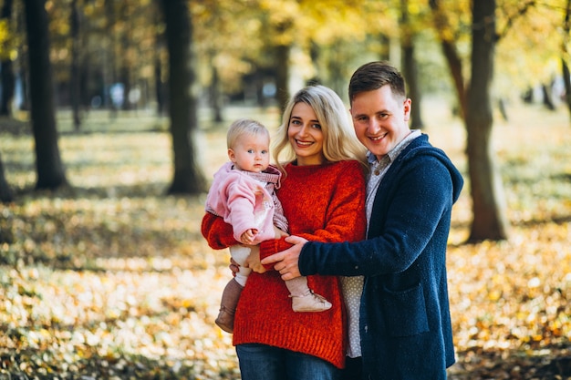 Family with baby daugher in an autumn park