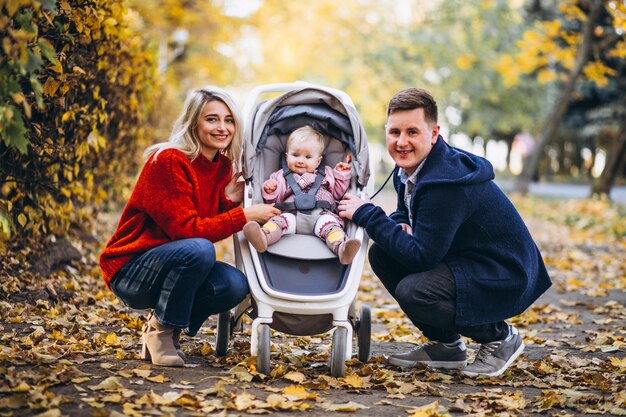 Family with baby daugher walking in an autumn park