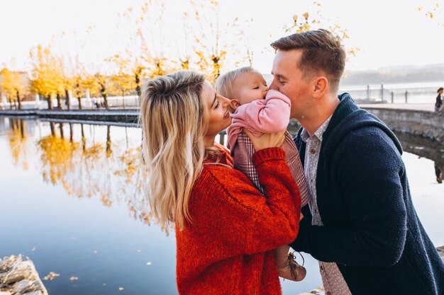 Family with baby daughter walking in park